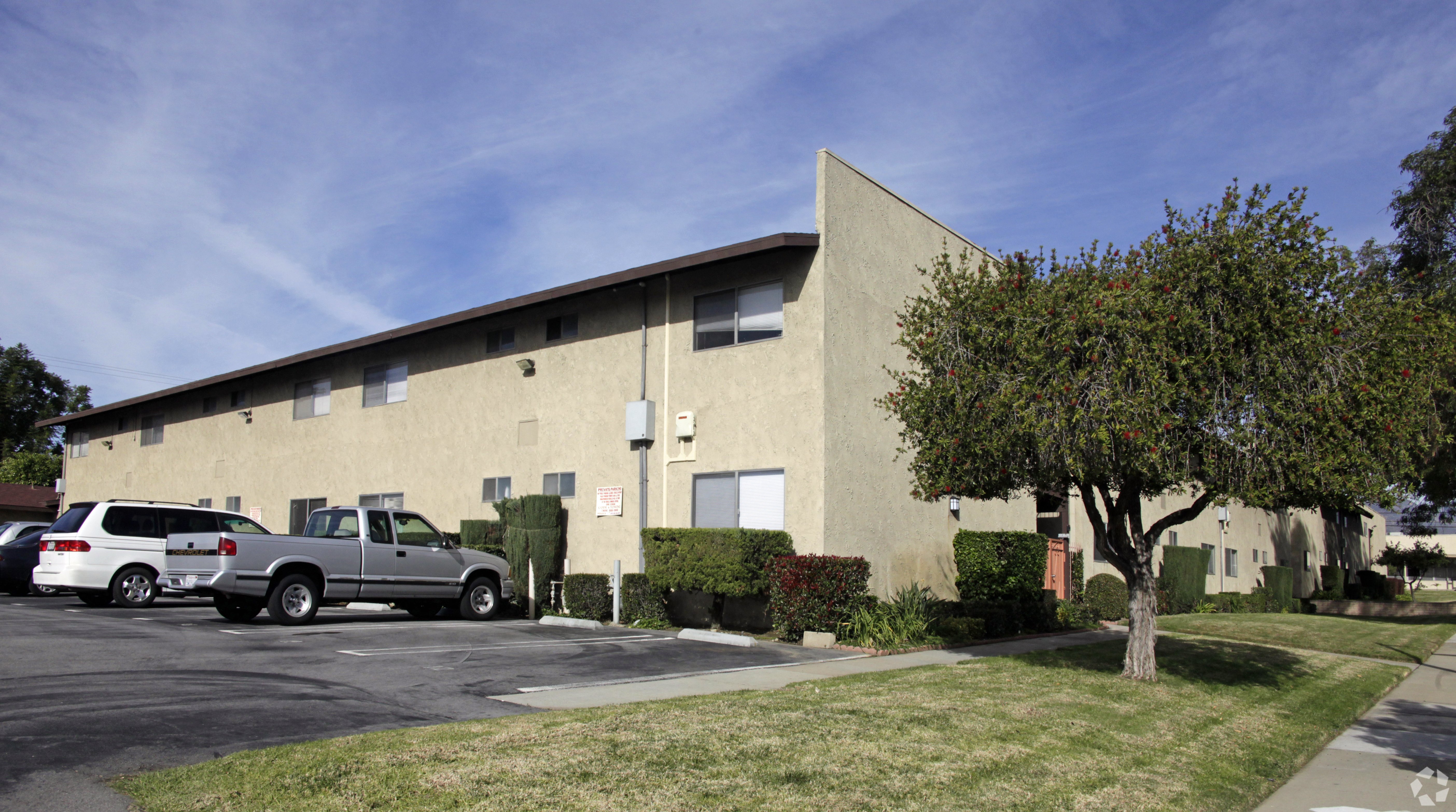 A building with a parking lot in front of it.